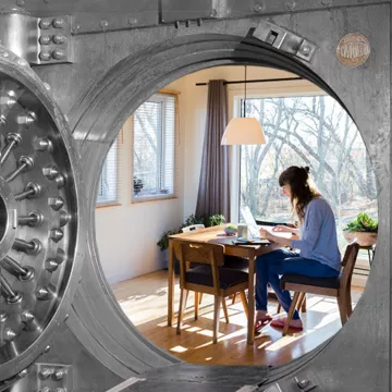 Woman on her laptop inside an open vault. 