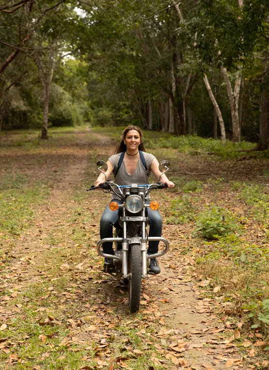MacDonald riding a motorcycle while on assignment in Guatemala. 