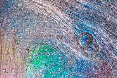textures formed by the bubbles and drops floating in water with colors in background.