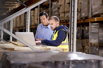 warehouse manager checks something with his supervisor