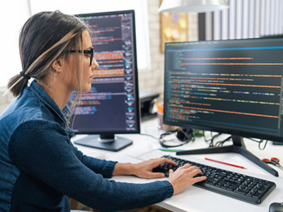 Woman coding in modern office setting